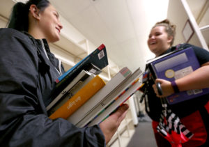 image of students with books in the University of Wisconsin-Stout library